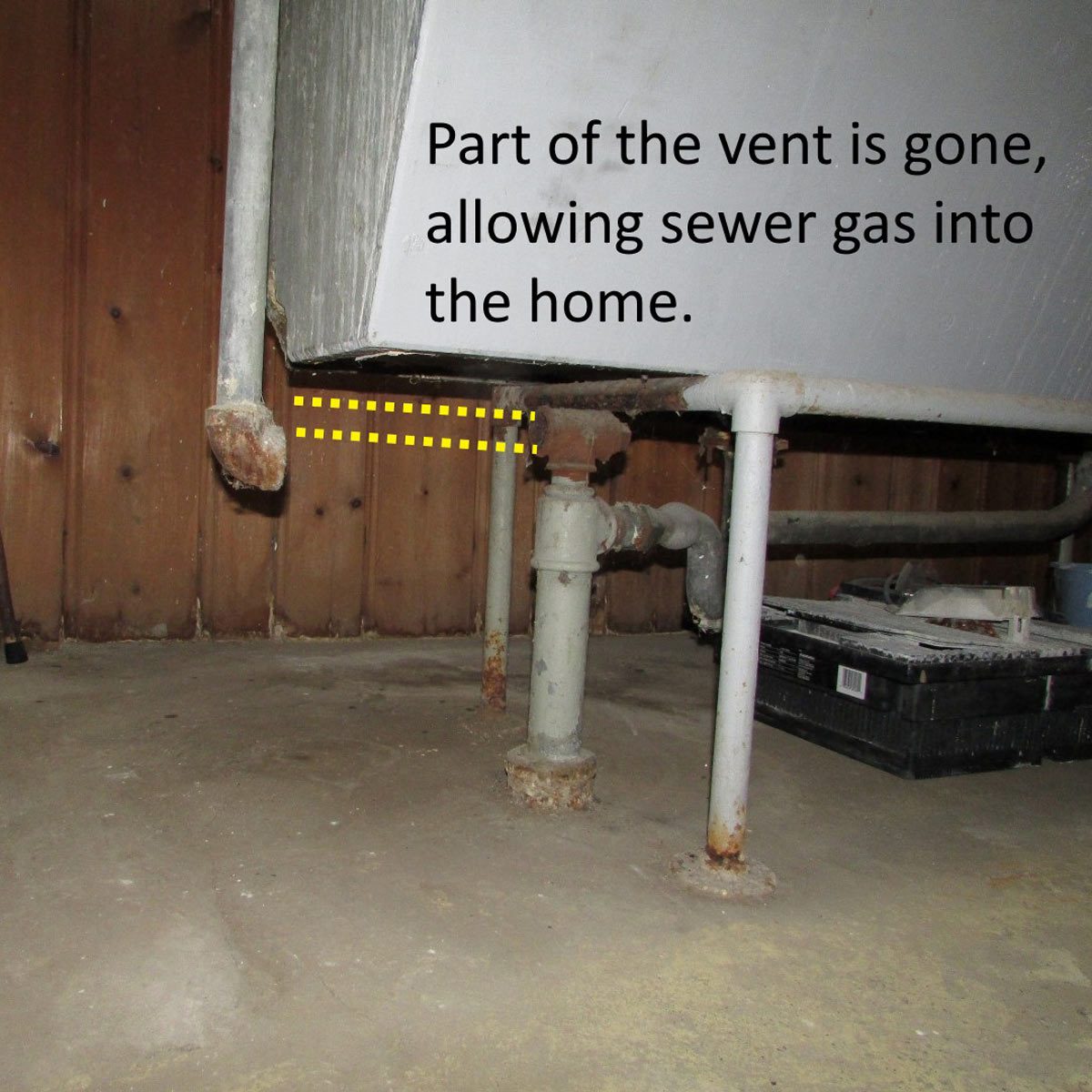 A damaged vent pipe allows sewer gas to enter a basement, situated on a concrete floor with wooden walls and rusting pipes nearby.