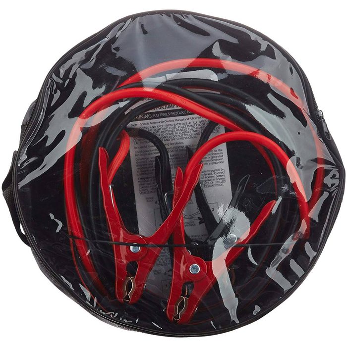 Red and black jumper cables rest coiled in a transparent, zippered bag, typically used for jump-starting vehicles in roadside emergencies.