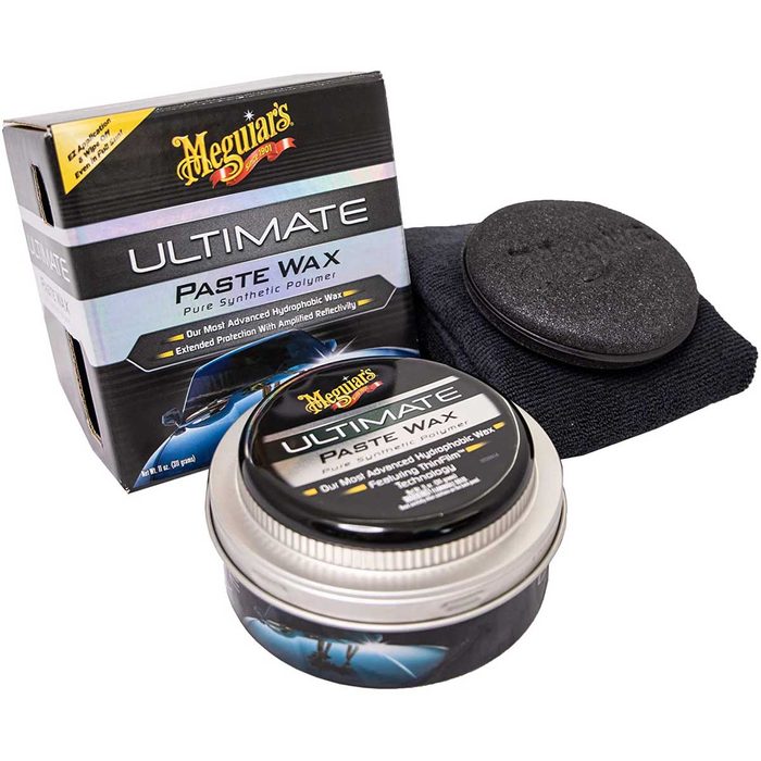 A round container of paste wax is displayed, accompanied by a sponge applicator and a microfiber cloth, all inside a branded box.