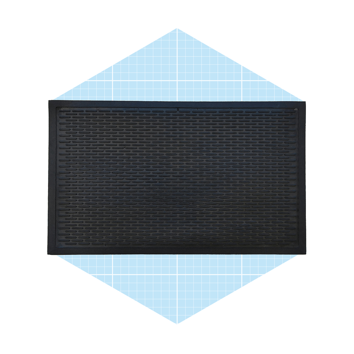 A black rubber mat lies flat, featuring a textured surface, against a light blue, grid-patterned background in a diamond shape.
