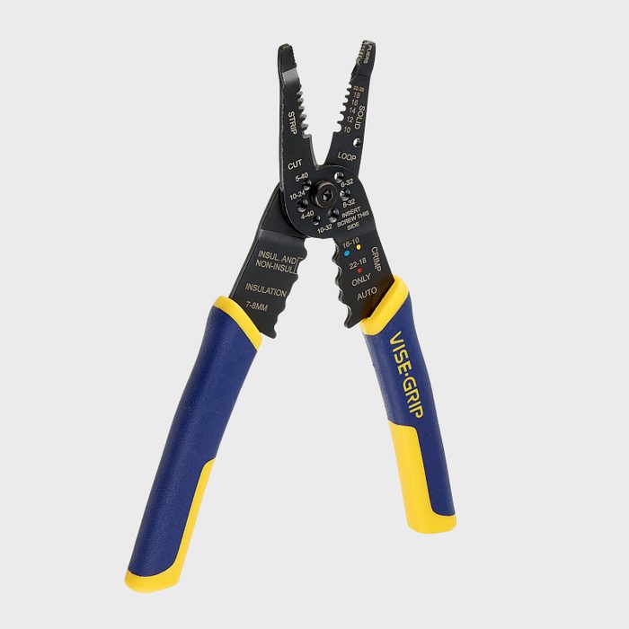 A pair of wire strippers with yellow and blue grips is positioned upright. It features multiple cutting and stripping functions marked on the metal jaws.