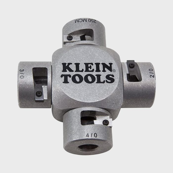 A metallic tool designed for cutting wires, featuring multiple openings labeled with sizes, positioned in a compact, cross-like configuration.