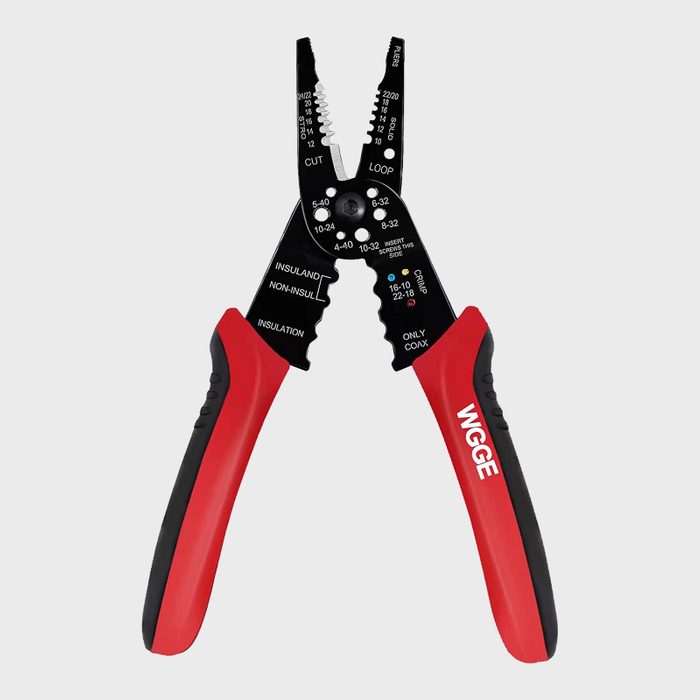 A pair of wire strippers is positioned upright, with the handles red and black. The tool showcases various measurements and cutting edges for electrical tasks.