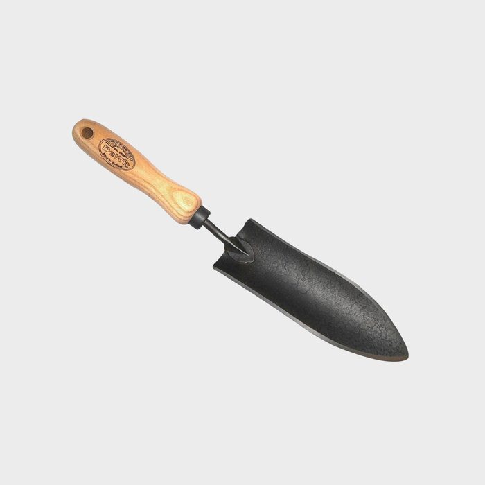 A hand trowel with a wooden handle and a pointed, black metal blade is positioned against a plain white background, ready for gardening tasks.