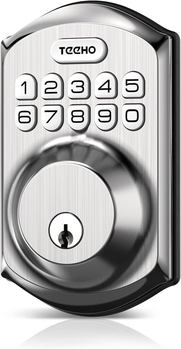 A digital door lock displays numbered buttons and a keyhole. It is designed for securing entryways and is situated against a smooth, metallic surface.