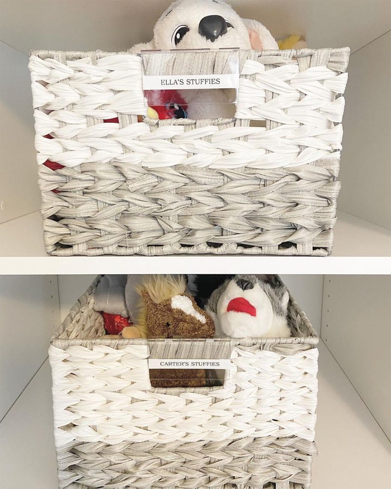 Two woven storage baskets hold stuffed animals labeled "Ella's Stuffies" and "Carter's Stuffies," organized on a white shelf in a tidy environment.