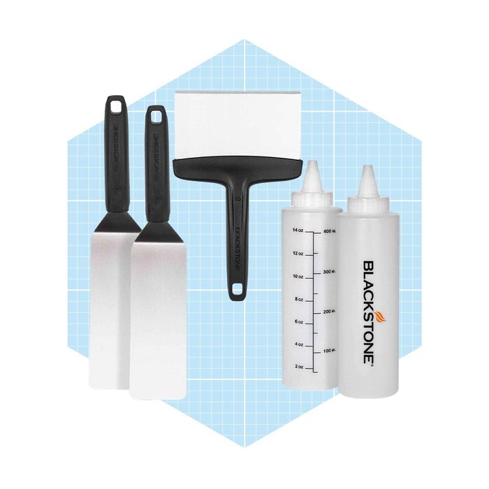 A set of kitchen tools, including spatulas and squeeze bottles, is arranged against a light blue grid background, ideal for food preparation or cooking.