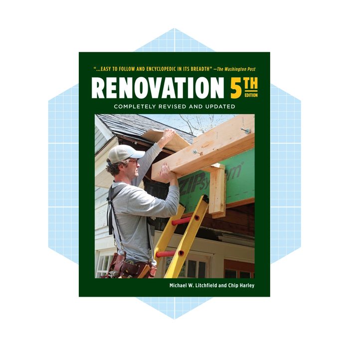 A man adjusts a wooden beam above a ladder while working on a house roof, surrounded by construction materials and tools.