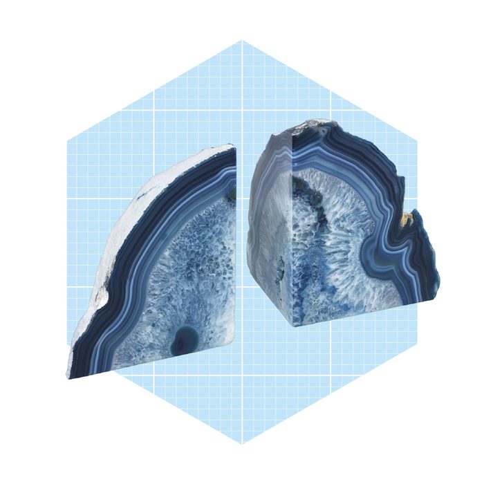 Two blue agate stone pieces are displayed, showcasing their natural patterns and textures against a light blue grid background.